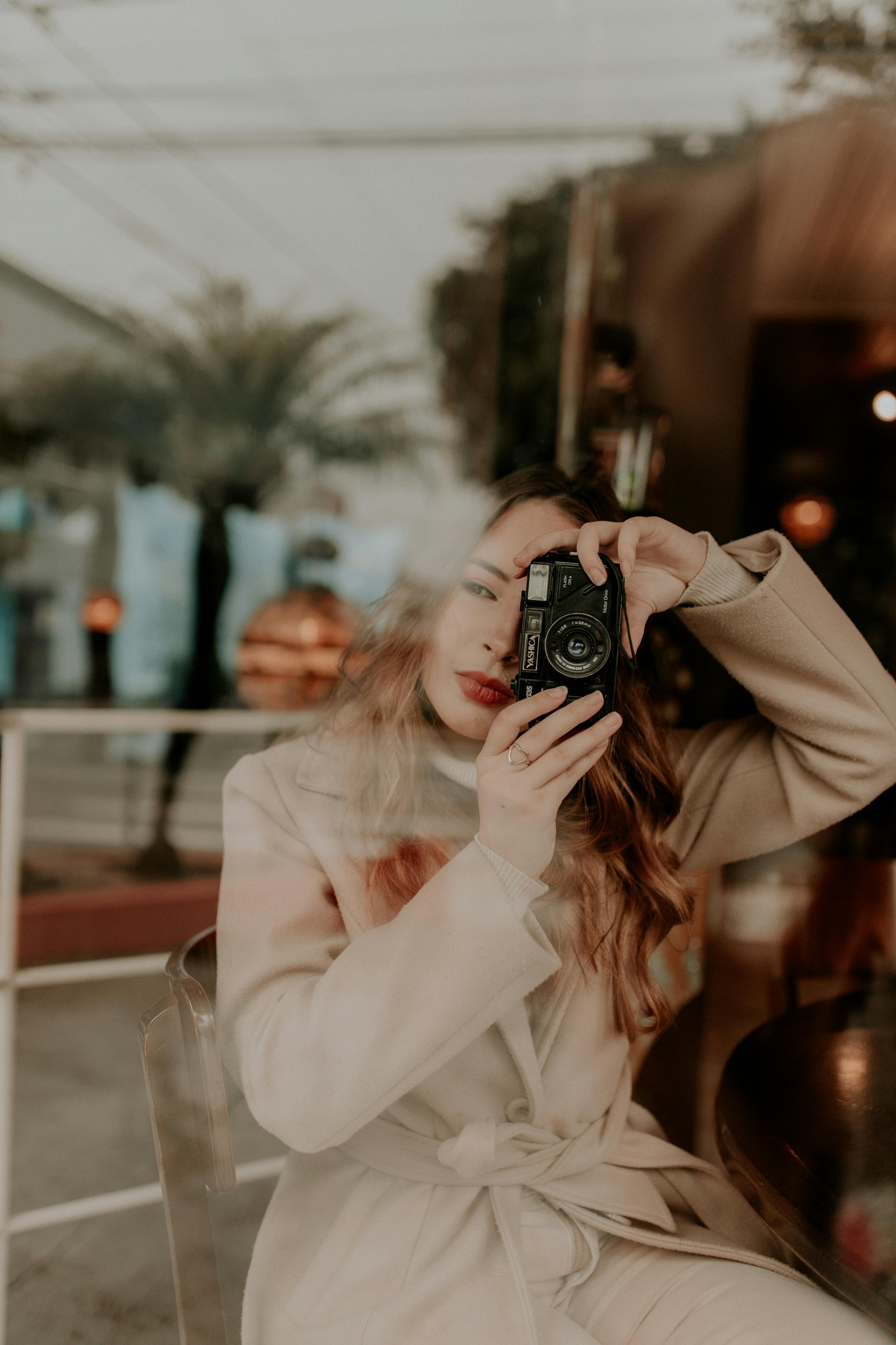 Blonde Woman Taking Picture Behind a Window · Free Stock Photo