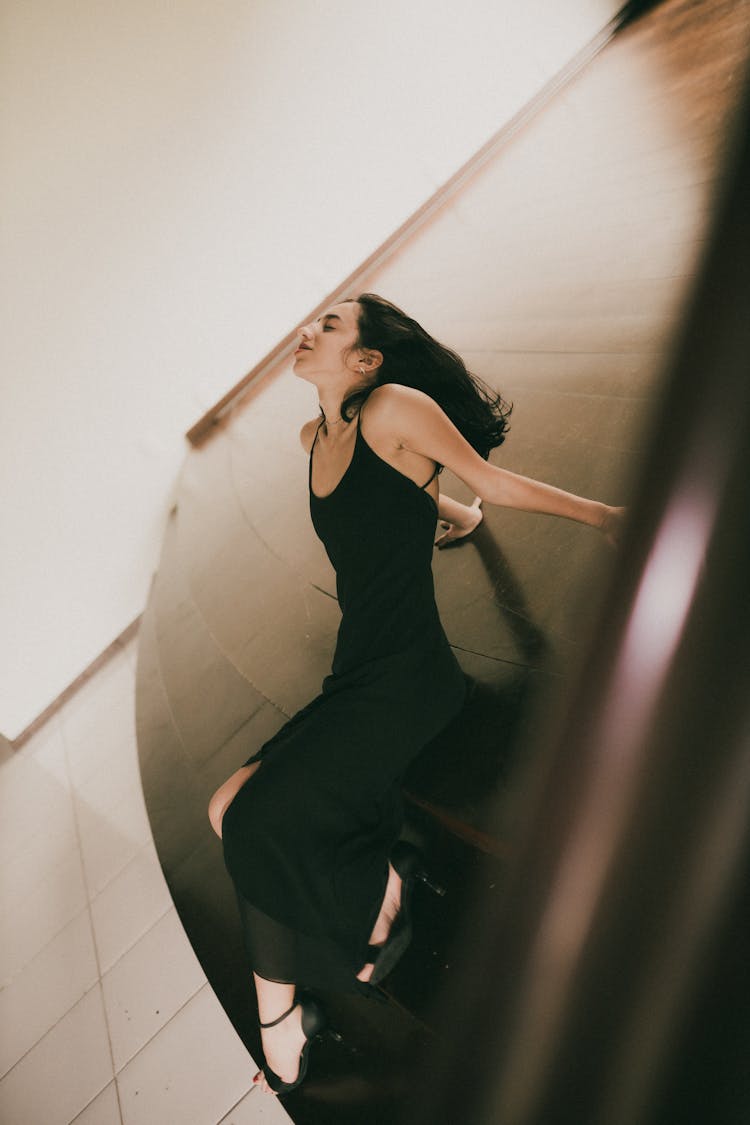 Woman Posing In Black Dress In Abstract Scenery 