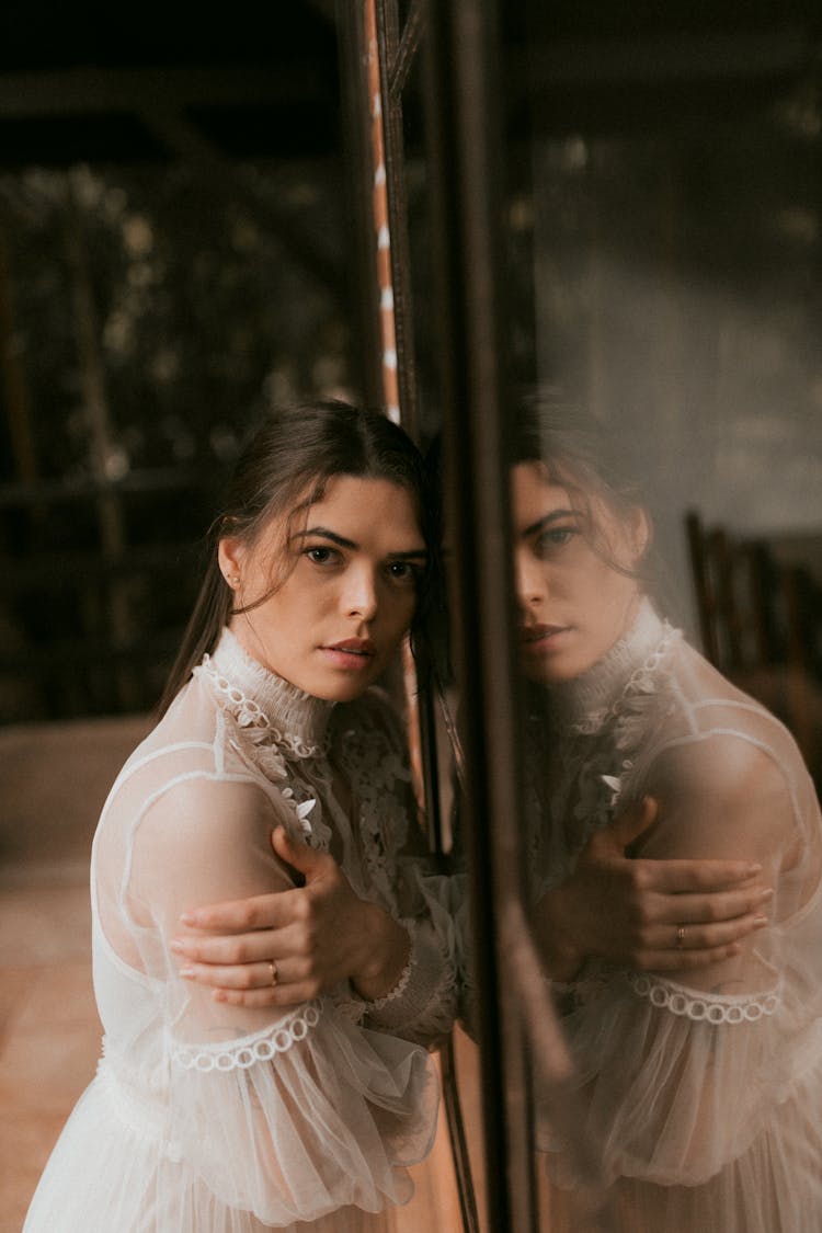 Reflection Of A Brunette Woman In A Mirror