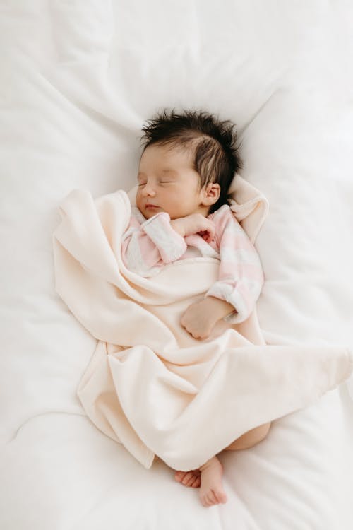 Free Toddler Sleeping in a Bed Stock Photo