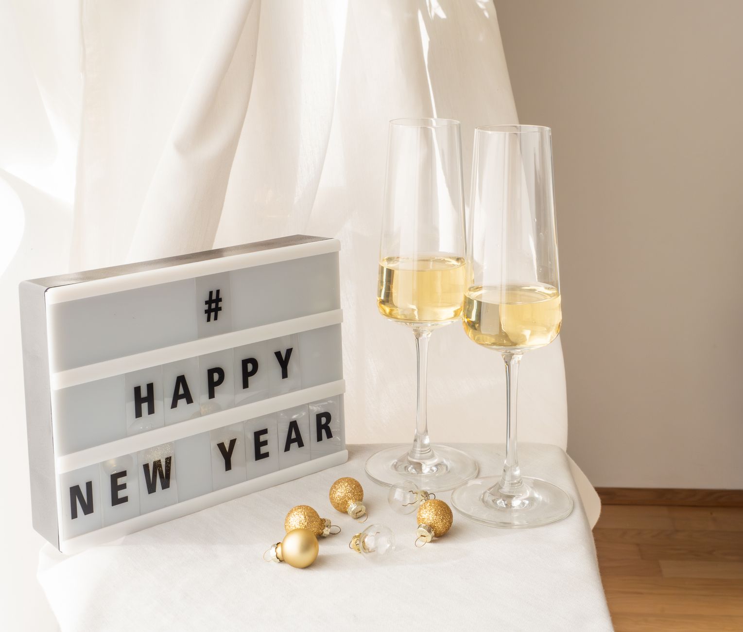 Sophisticated New Year celebration scene with champagne and decorative elements.