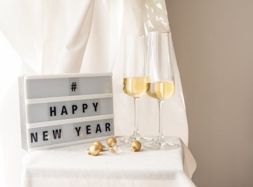 Bright New Year Still Life with Champagne Glasses and Golden Baubles