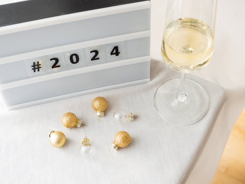 Bright New Year Still Life with a Champagne Glass, Gray Board, and Golden Baubles