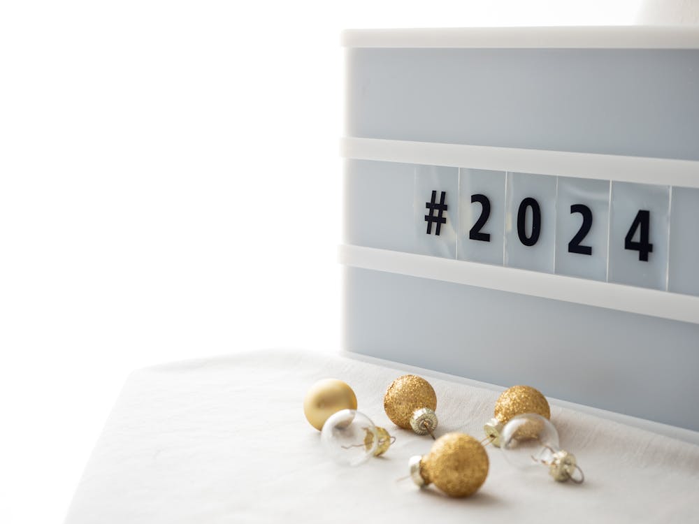 Free Photo Of Festive Decorations With Champagne Glasses On A White Background And A Lightbox With The Hashtag 2024 ?auto=compress&cs=tinysrgb&w=1260&h=750&dpr=1