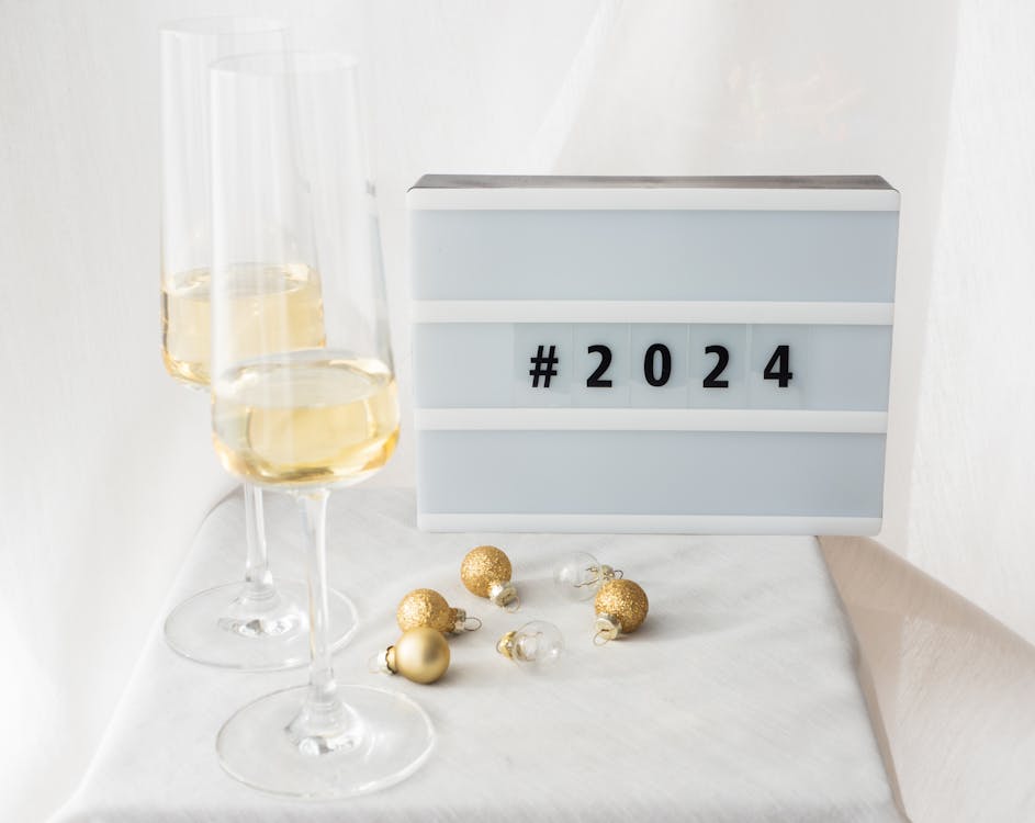 Free Photo Of Festive Decorations With Champagne Glasses On A White Background And A Lightbox With The Hashtag 2024 ?auto=compress&cs=tinysrgb&w=1260&h=750&dpr=1