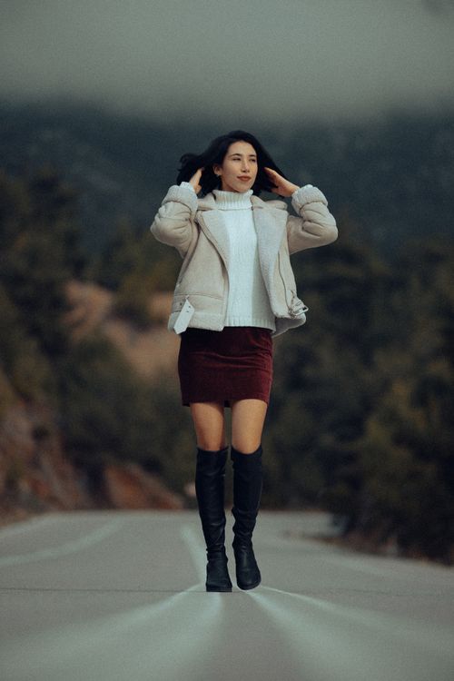 Free Elegant woman in fall fashion walking on a rural road in Fethiye, Türkiye, showcasing autumn style. Stock Photo