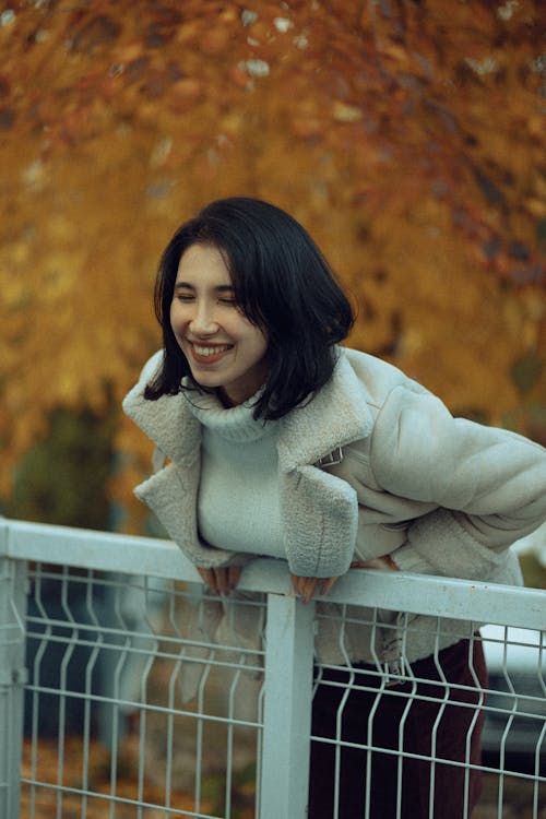 Young Woman in an Elegant Autumnal Outfit Posing Outside 