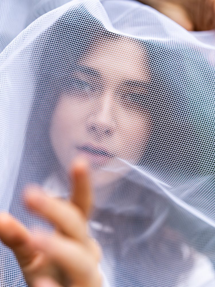 Photo Of A Woman With Mesh Fabric On Her Face