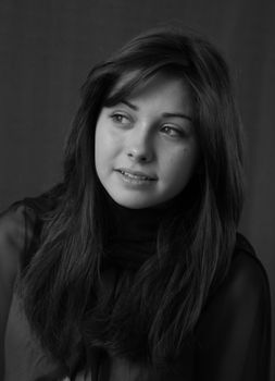 Black and white portrait of a young woman looking thoughtfully to the side.