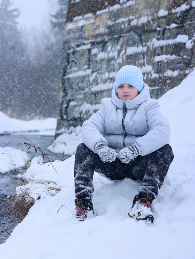 Child Model In Puffer Jacket In Snowy Winter