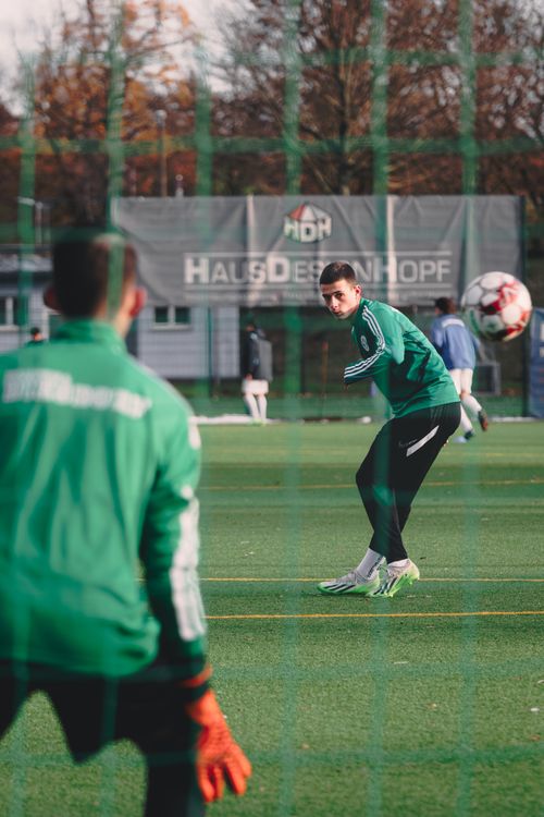 Free Two men training soccer on an outdoor field during autumn, focusing on goalkeeping skills. Stock Photo
