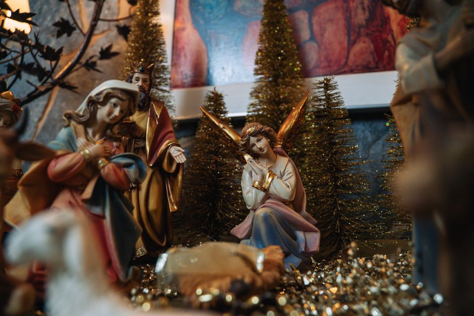 Close-up of a Christmas nativity scene featuring angel figurines and festive decorations.