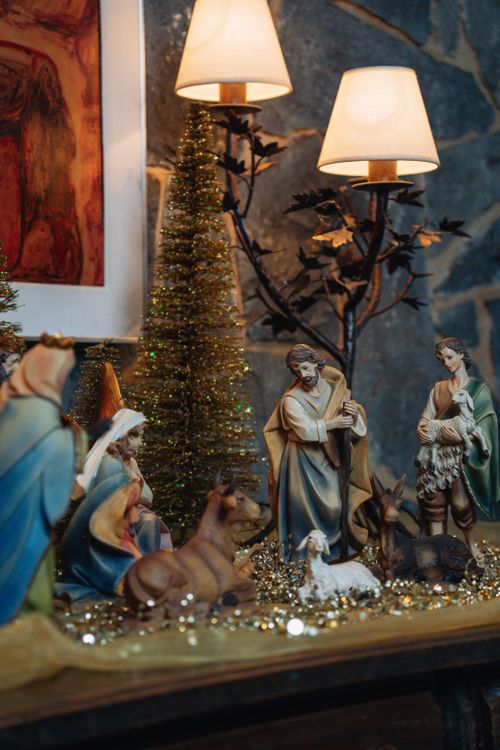 Free Cozy indoor nativity scene with figurines and festive Christmas decor, capturing holiday warmth. Stock Photo