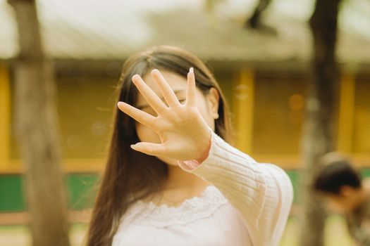 Woman Obsuring Face with Hand
