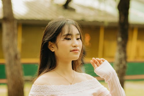 Photo of a Girl Wearing a Blouse with a Lace Ornament