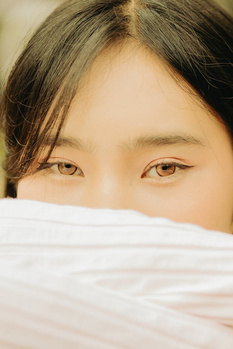 Close-up Photo Of A Young Woman Covering Half Of Her Face