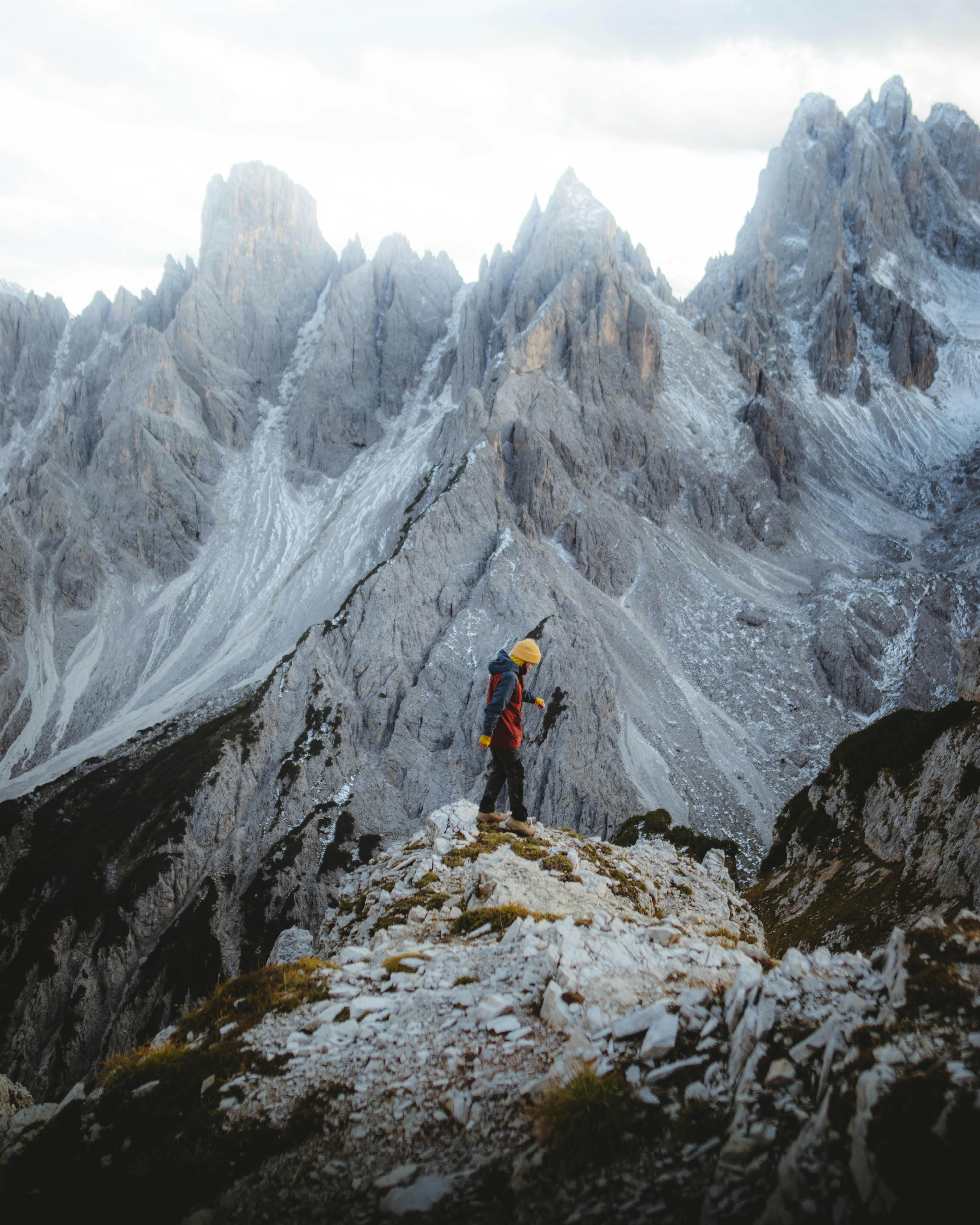 Hiker stands on rocky terrain in the stunning Dolomites, Trentino-South Tyrol, Italy.