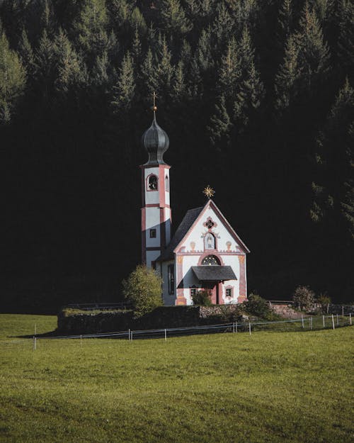 Catholic Church Erected in a Meadow with Forest Trees in the Background