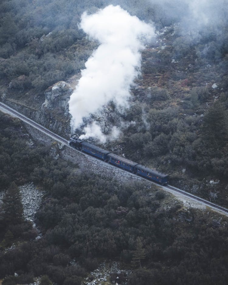 Aerial Shot Of Train In Mountains