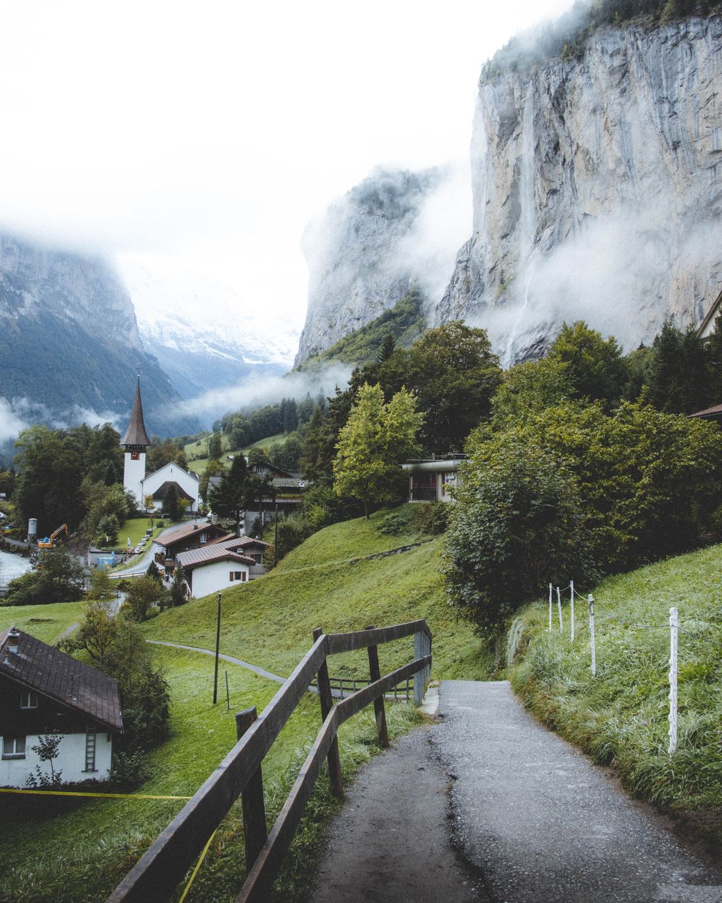 Discover the breathtaking landscapes of Lauterbrunnen, Switzerland, with misty mountains and charming village life.