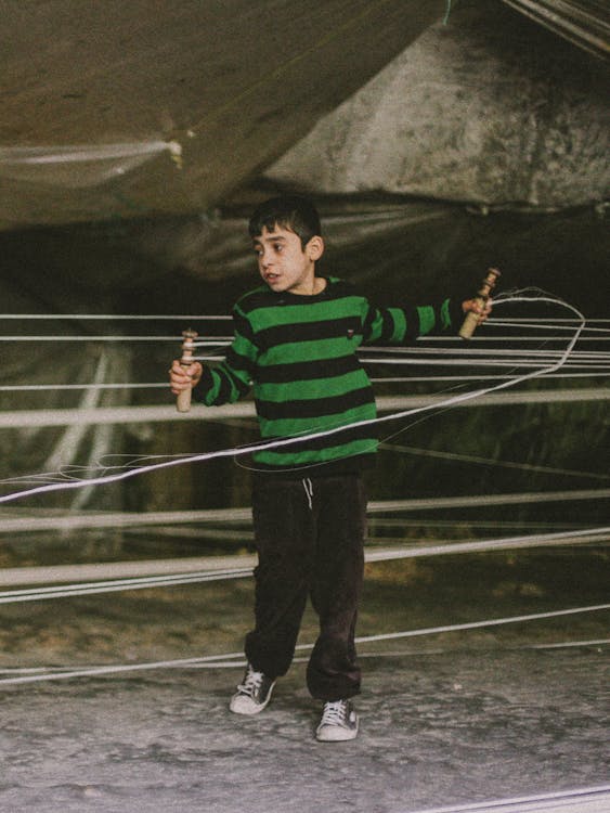 A Boy Preparing the Threads for Weaving · Free Stock Photo