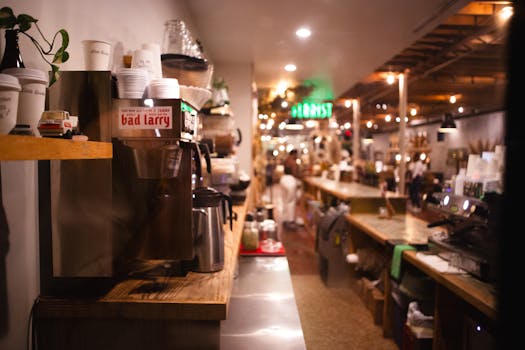 Warm and inviting night ambiance inside an Austin café featuring coffee machine and decor.