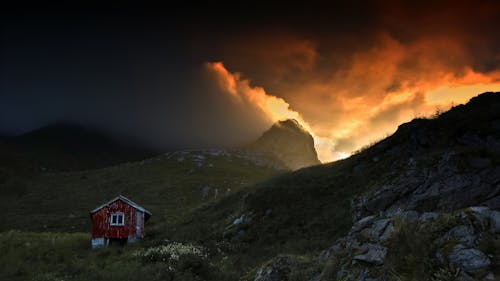 Clouds over Mountains and Cottage at Sunset