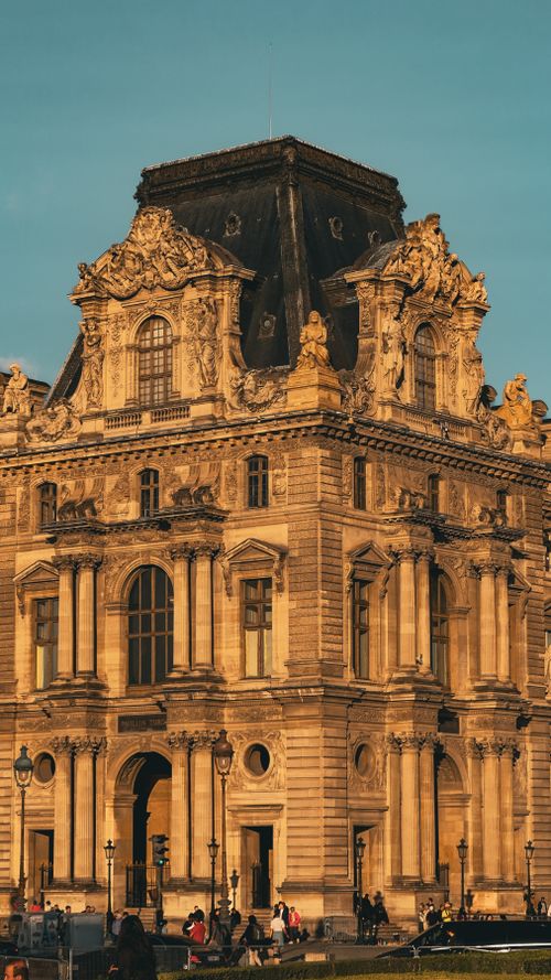 Free Beautiful view of Louvre Palace facade in Paris during sunset, showcasing historic architecture. Stock Photo
