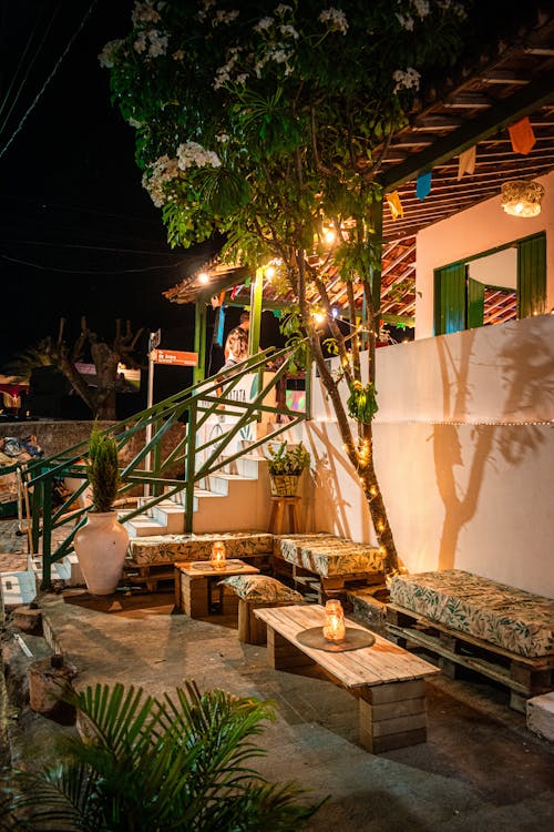 A Patio and Facade of a Building Illuminated in the Evening 