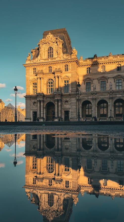 Louvre Building and Reflection in Puddle