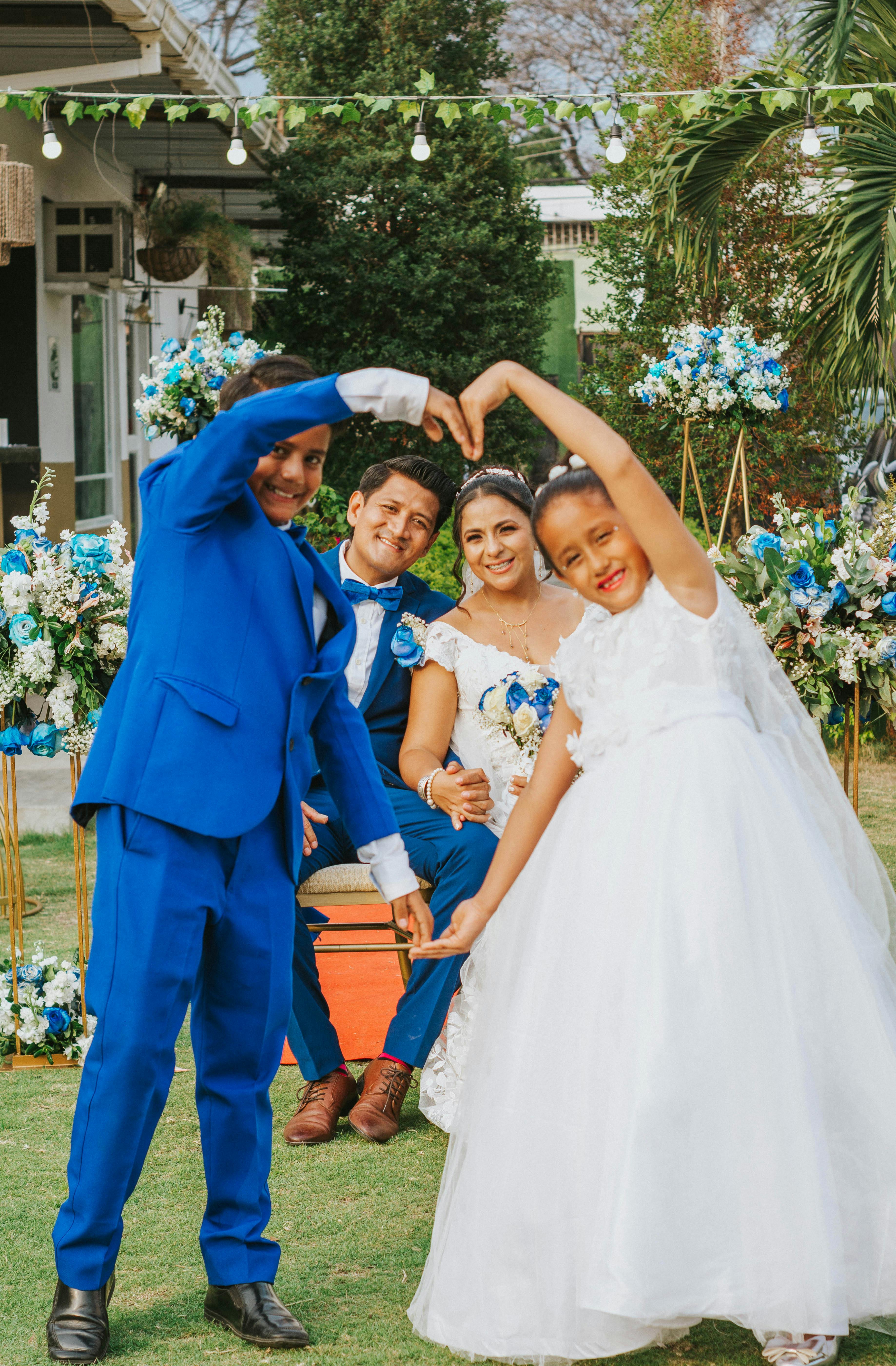 A vibrant wedding ceremony in Guayaquil featuring a happy couple and children creating a heart shape.