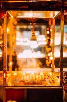 Captivating street food stand in Istanbul, showcasing sizzling delights under warm lights.