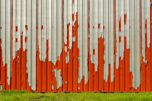 Red Paint Peeling off the Galvanized Corrugated Sheet Metal Wall