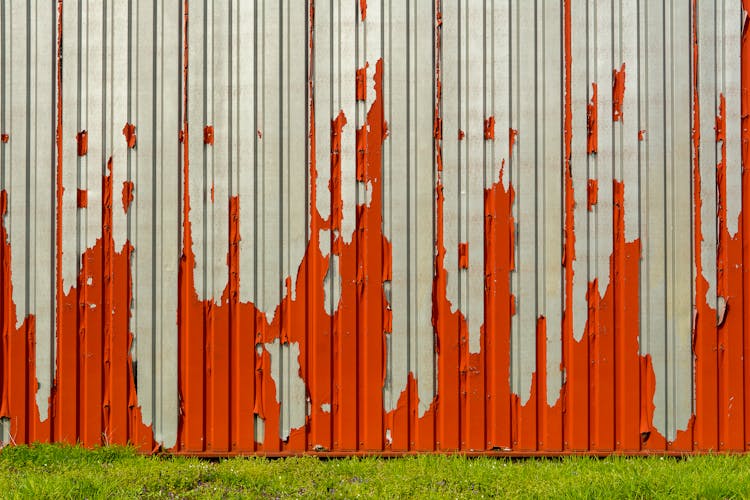 Red Paint Peeling Off The Galvanized Corrugated Sheet Metal Wall