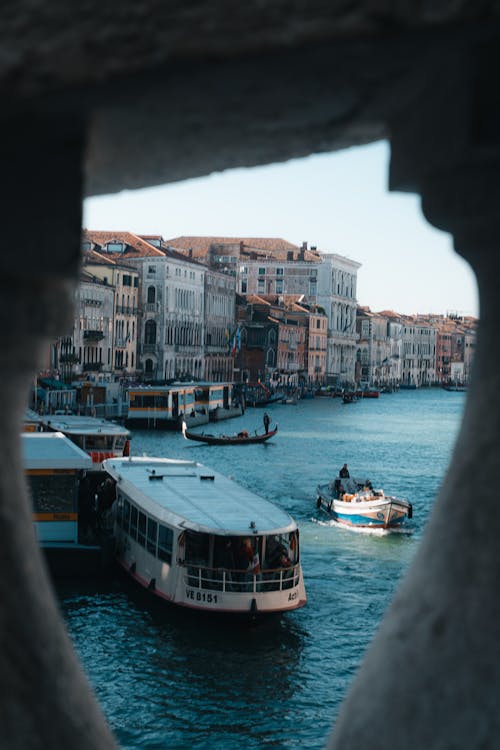 View of Boats on the Canal and Apartment Buildings in Venice, Italy 