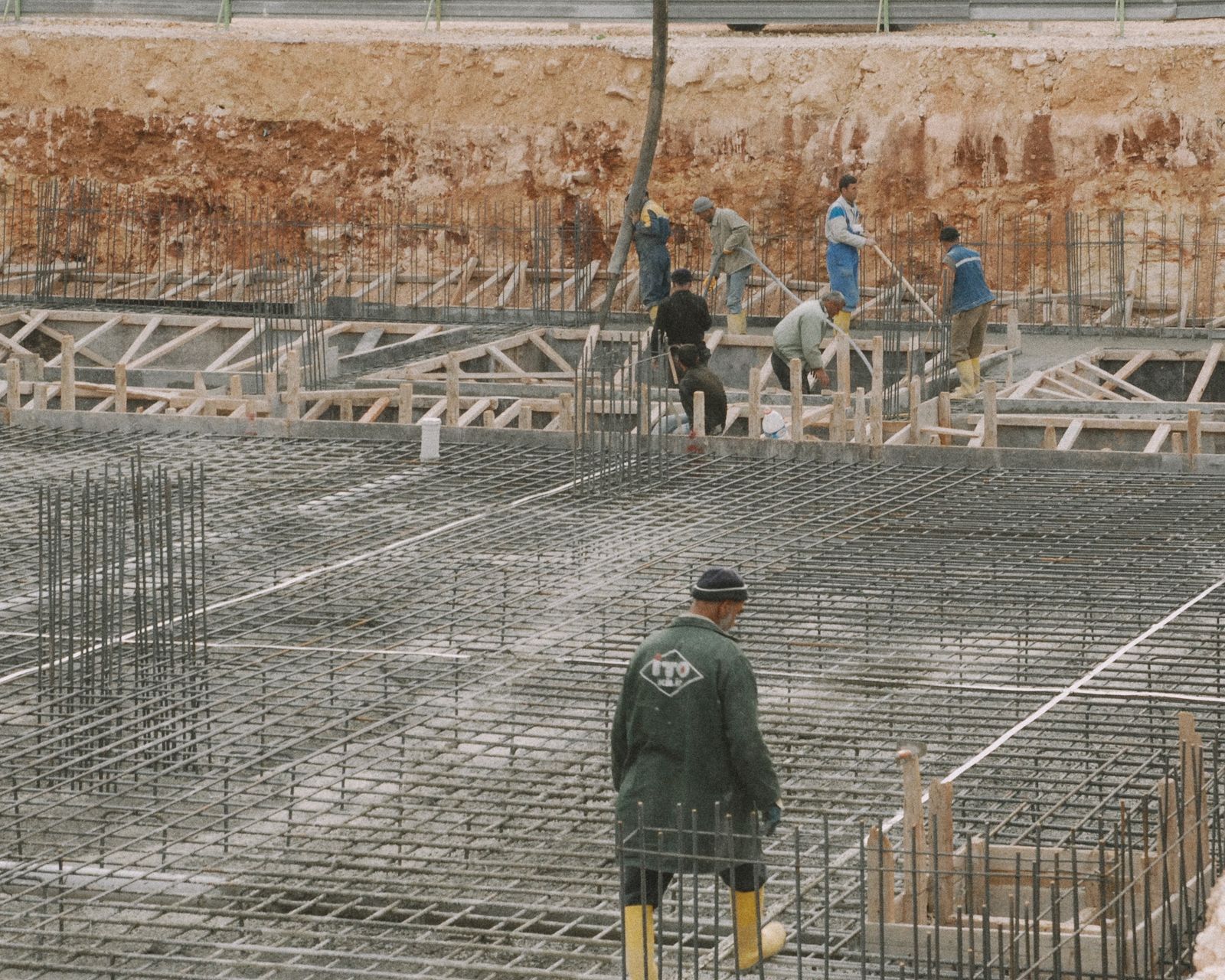 Construction crew laying steel reinforcement for an RCC foundation in Mumbai Construction crew laying steel reinforcement for an RCC foundation in Mumbai