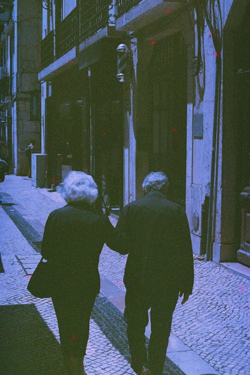 Free Elderly Couple Walking on a Street  Stock Photo