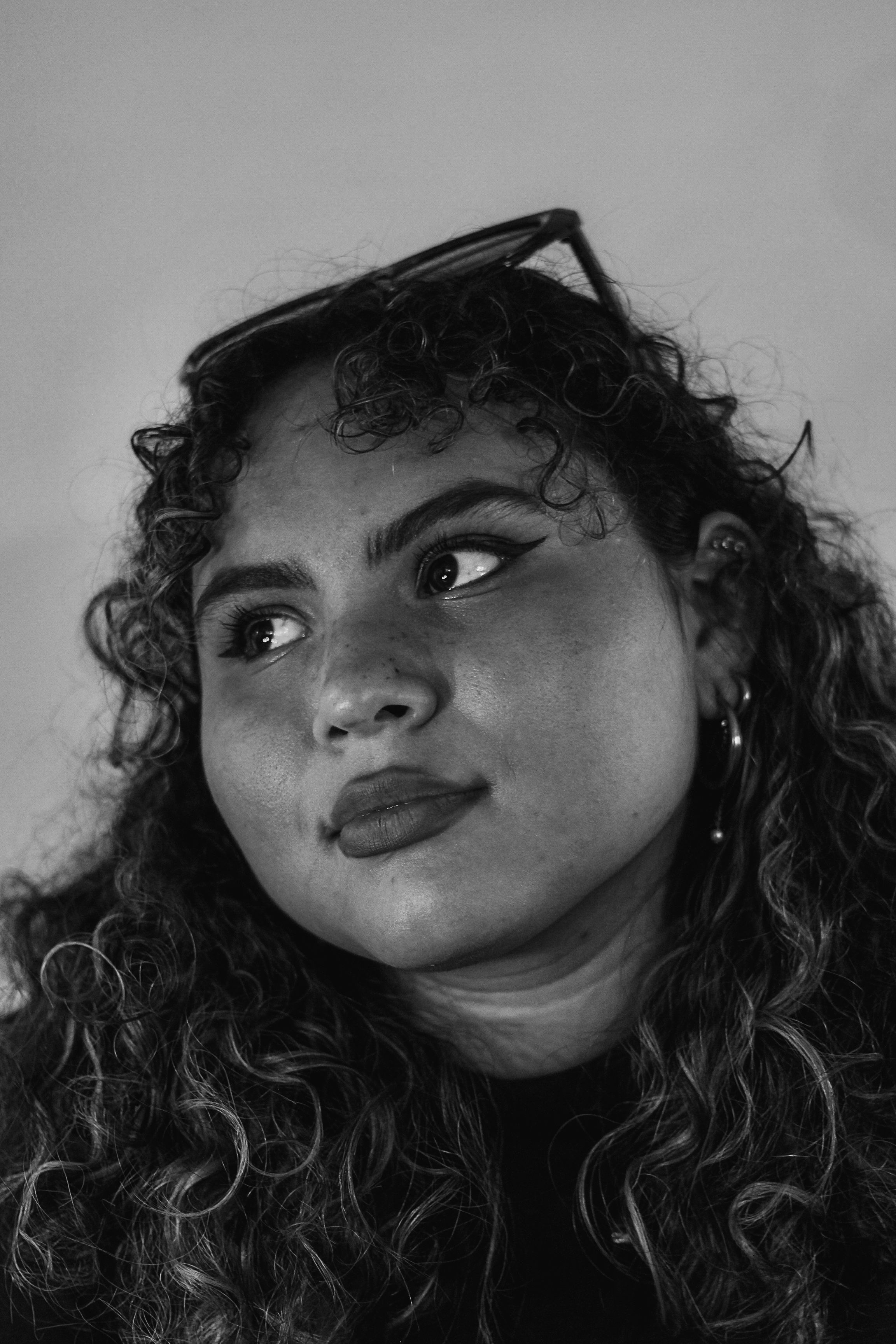 Black and White Portrait of a Woman with Curly Hair · Free Stock Photo