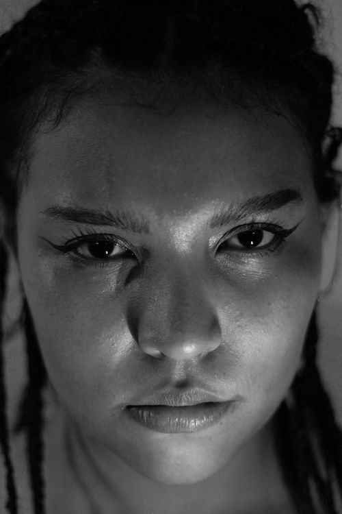 Free Black and white close-up portrait of a woman with braided hair, emphasizing intense emotions. Stock Photo
