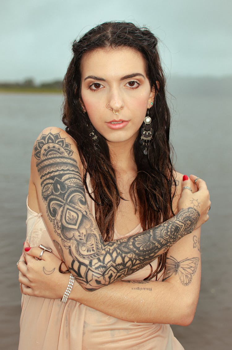 Brunette Woman With Tattoo And Nose Piercing