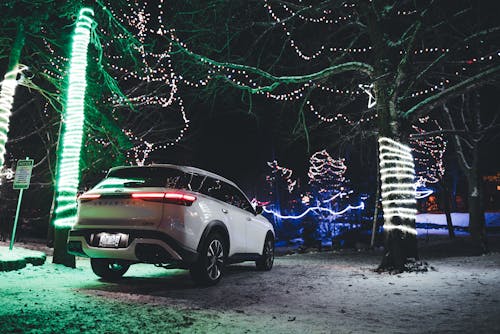 White Car on a Street Decorated with Lights