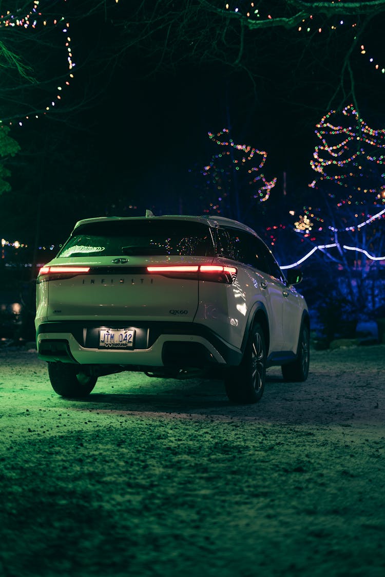 Back Of A Car Illuminated By Christmas Lights