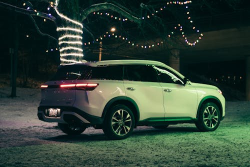 Infiniti QX60 by Decorated Tree at Night
