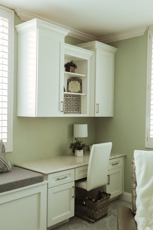 Hanging Cabinet Above a White Desk with a Marble Top