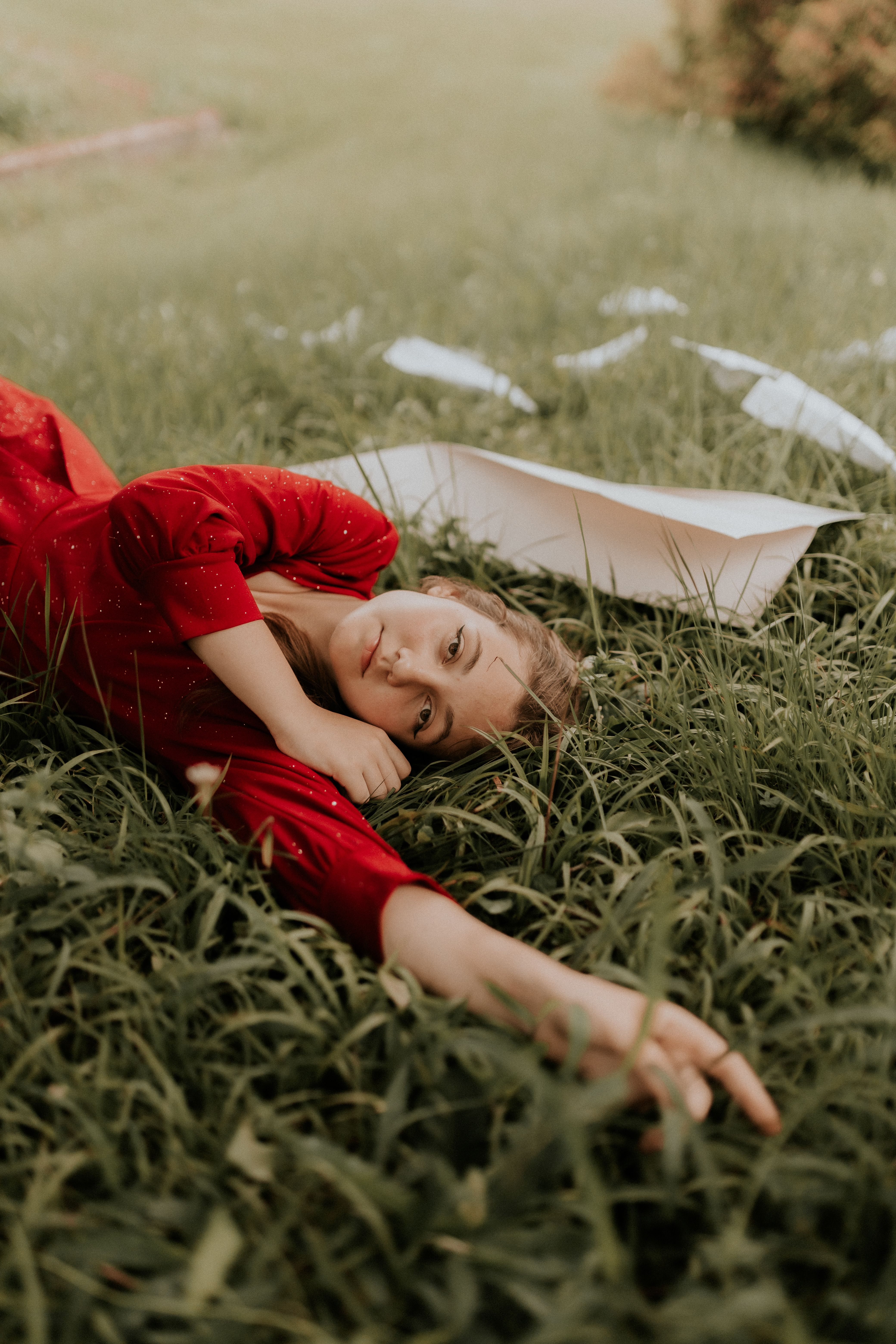 Brunette Woman in Red Dress Lying on Grass · Free Stock Photo
