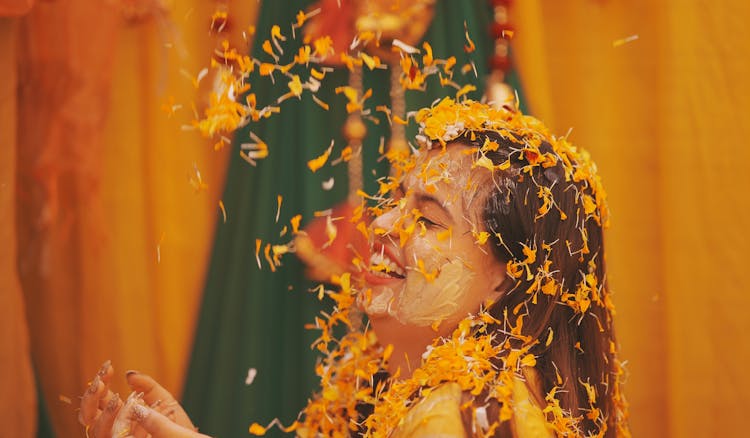 Orange Flowers Falling On A Woman 