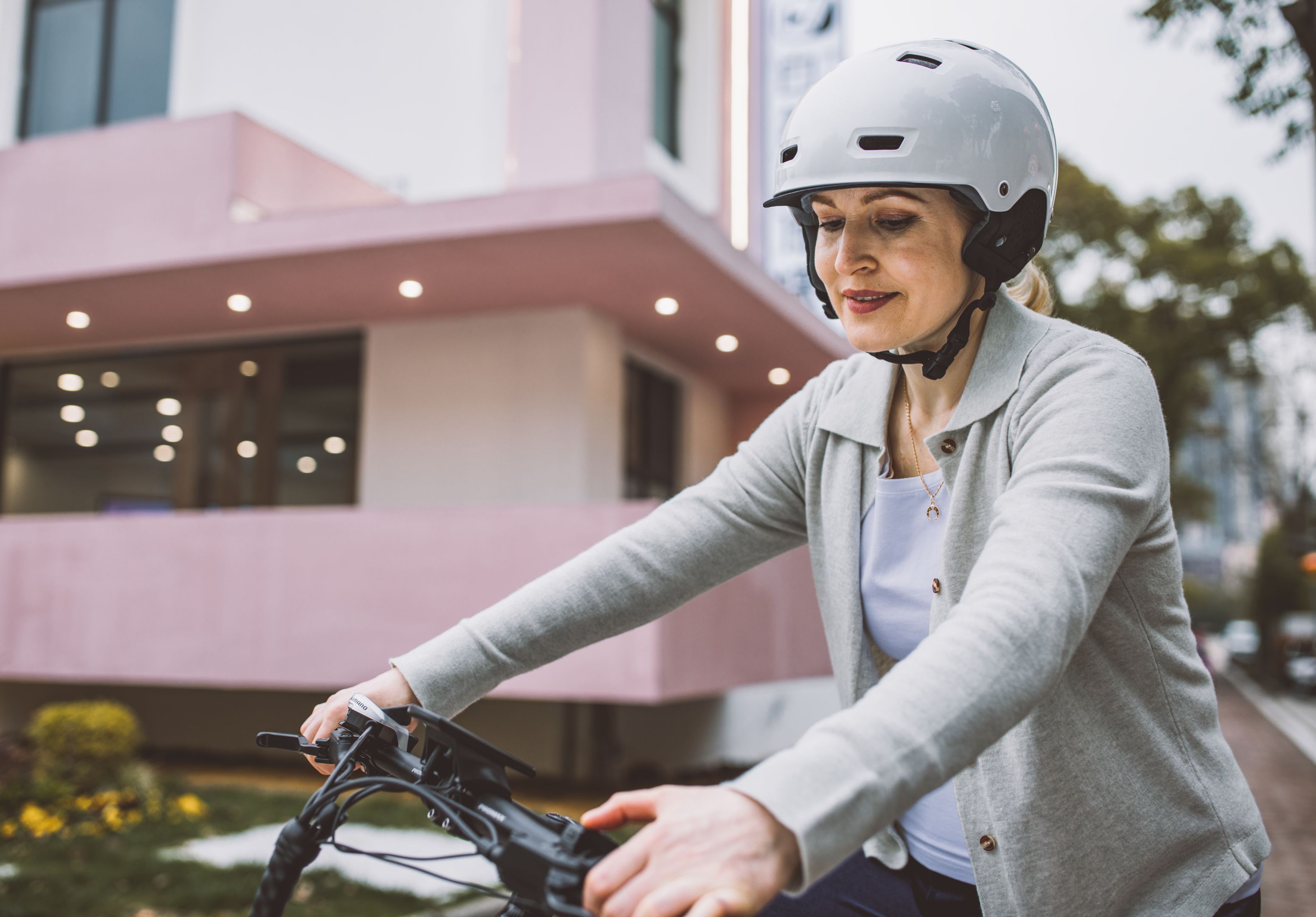 A woman wearing a helmet riding a bike · Free Stock Photo