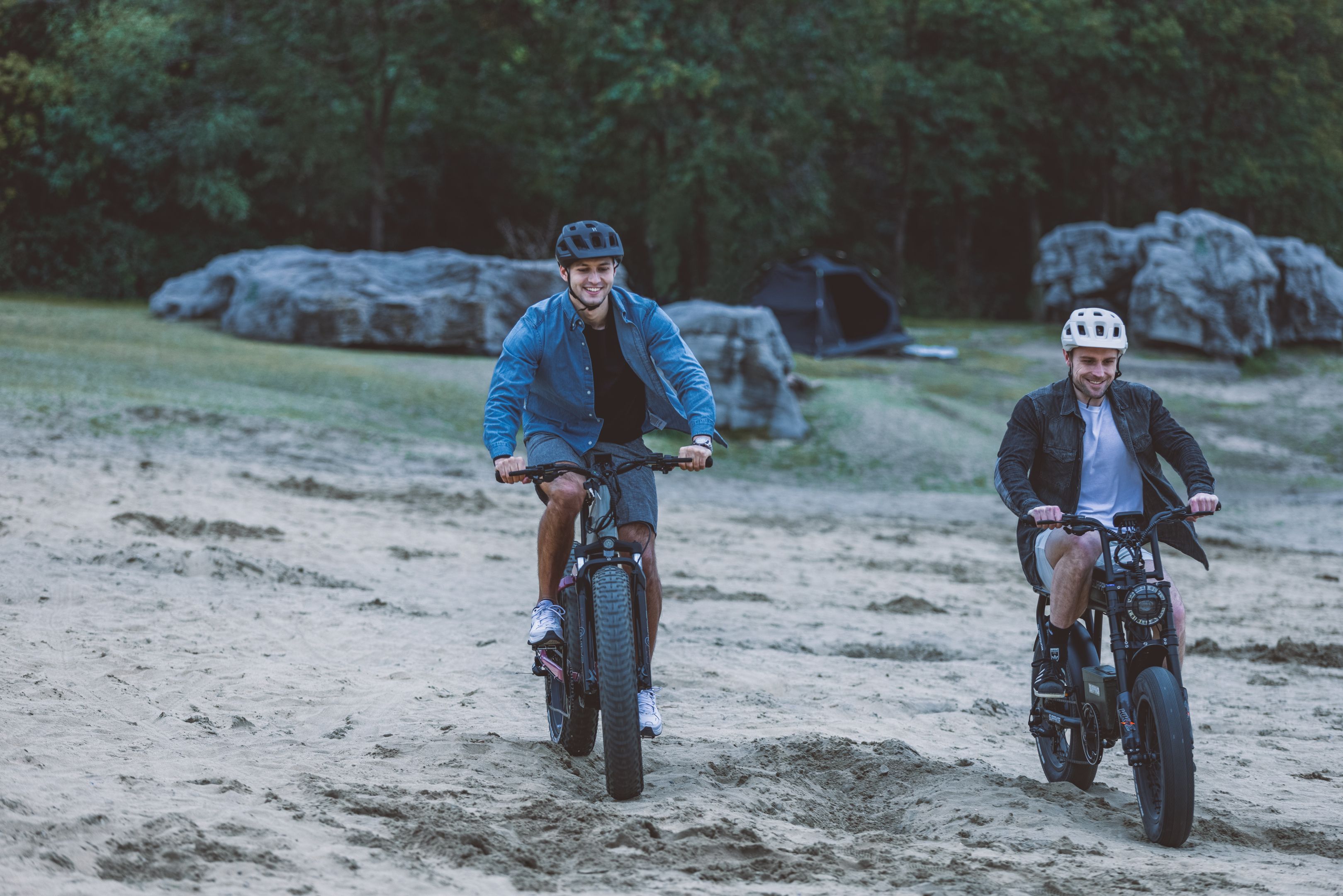 Two Young Men Riding Electric Bikes on Sand · Free Stock Photo