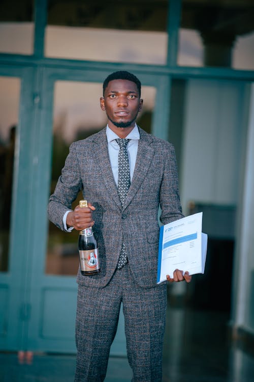 Elegant Man Holding Files and Bottle of Champagne 