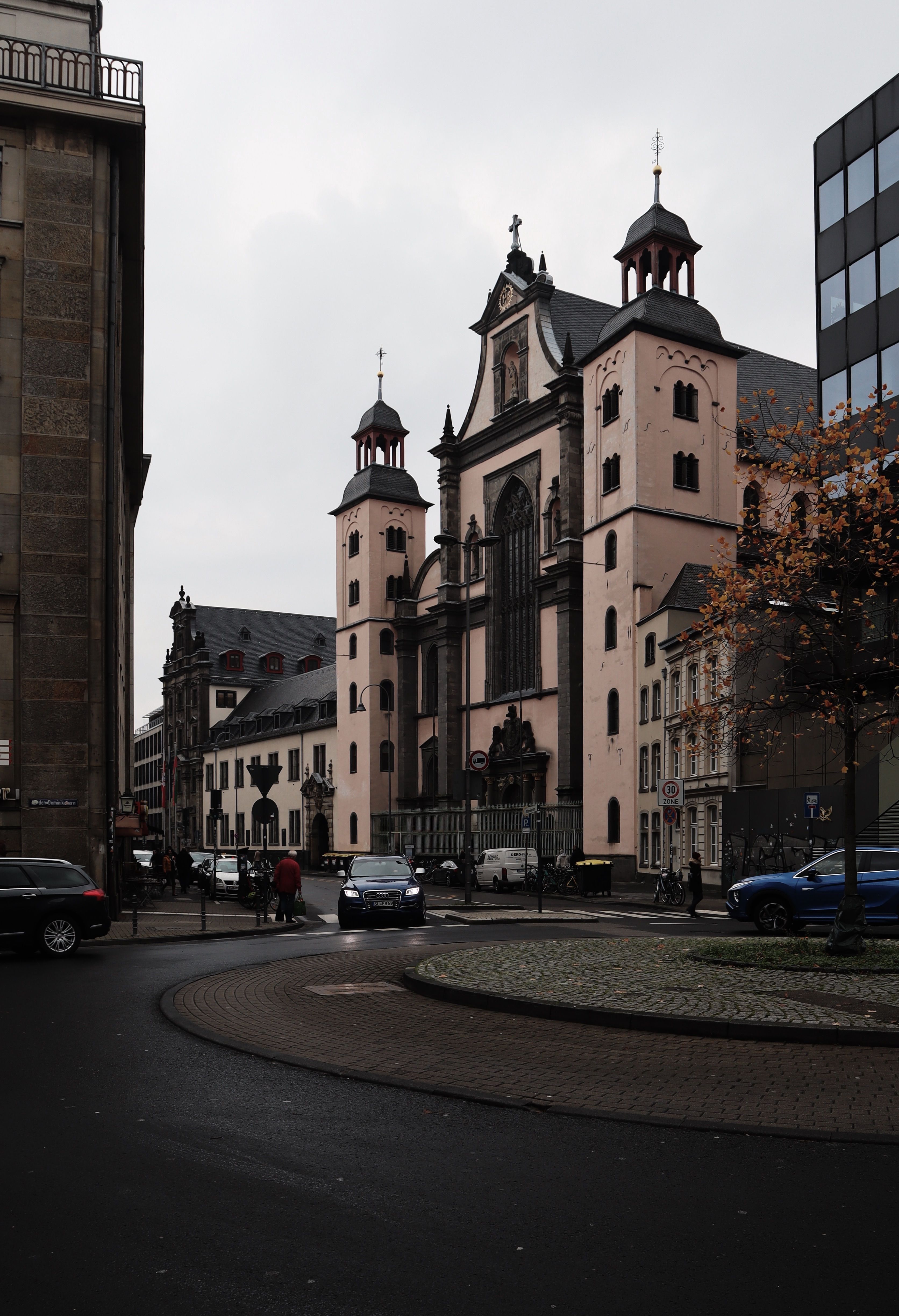 Urban scene with Maria Himmelfahrt Church in Cologne, Germany, during daytime.